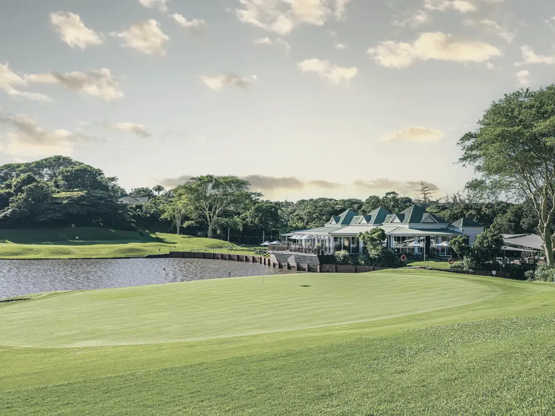 The green and clubhouse at Mount Edgecombe Country Club Estate, framed by the water hazard