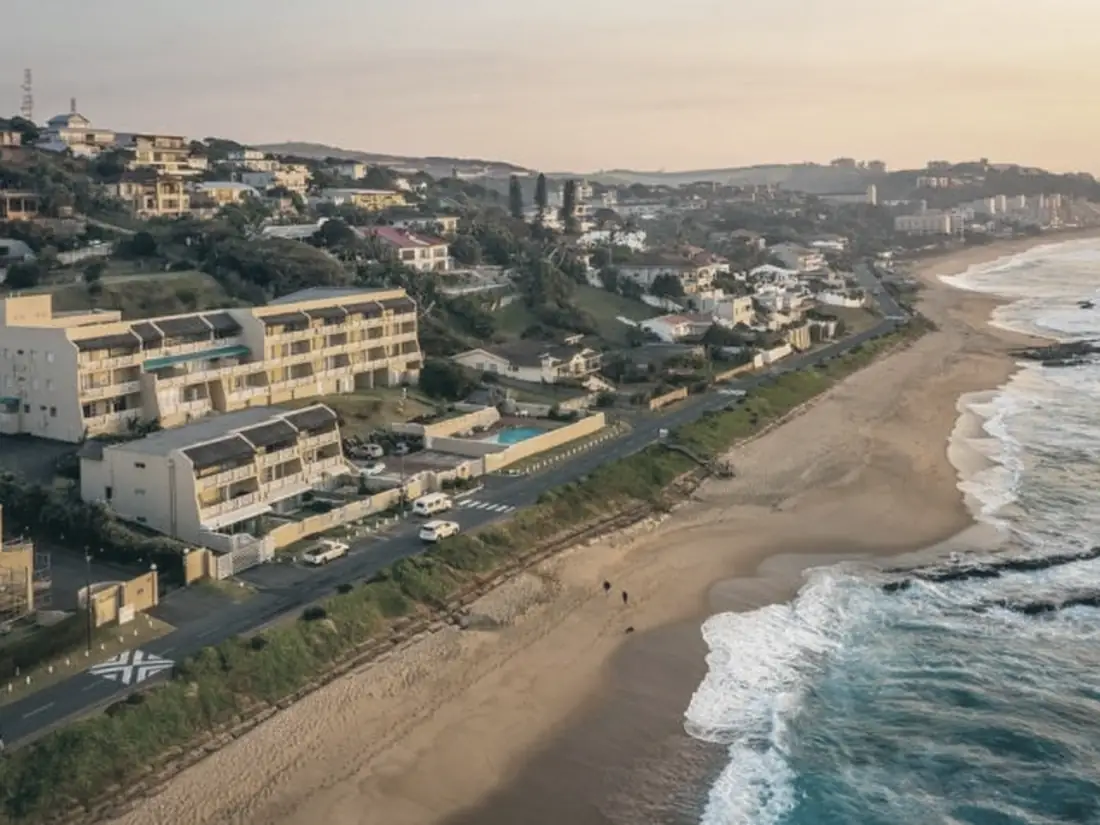 Aerial view of Umdloti's beachfront apartments stepping down the hillside to the surf